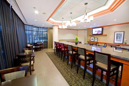 a dining room with a bar and tables and chairs at Hampton Inn - Vancouver Airport/Richmond in Richmond