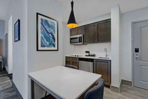 a kitchen with a white counter top in a room at Homewood Suites by Hilton London Ontario in London