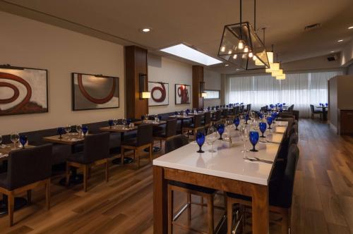 a row of tables and chairs in a dining room at Doubletree by Hilton London in London