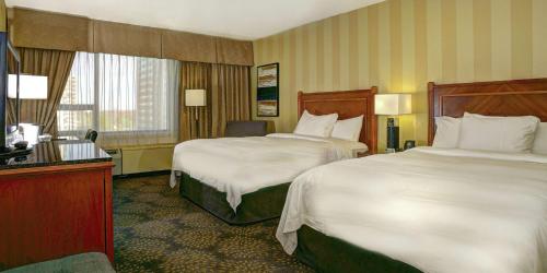 a hotel room with two beds and a television at Doubletree by Hilton London in London