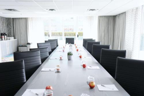a long table in a conference room with chairs at Hampton Inn & Suites, by Hilton - Vancouver Downtown in Vancouver