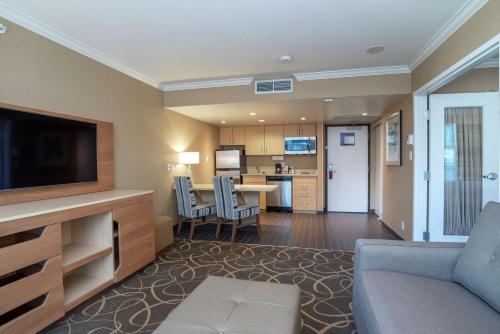 a living room with a couch and a dining room at Hampton Inn & Suites, by Hilton - Vancouver Downtown in Vancouver