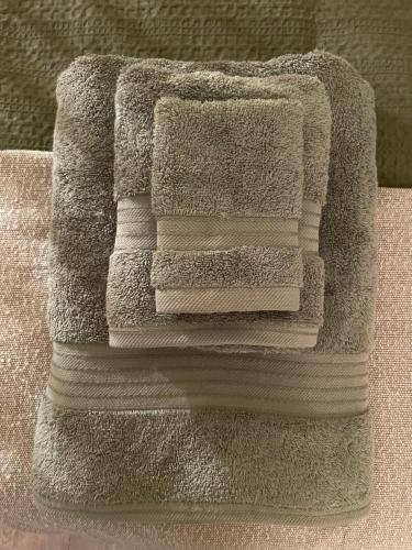 a pile of towels stacked on top of each other at The Cotswold Nook in Dursley