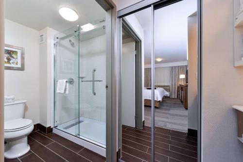 a bathroom with a shower and a toilet at Hampton Inn & Suites by Hilton Calgary University NW in Calgary