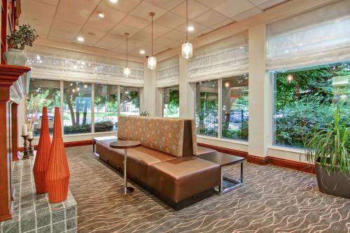 a lobby with a couch and a table and windows at Hilton Garden Inn Toronto/Burlington in Burlington