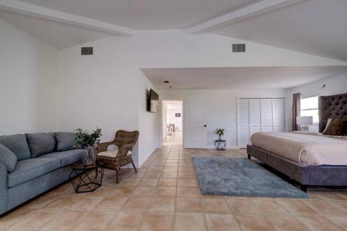 a living room with a bed and a couch at Bean Point Residence in Anna Maria