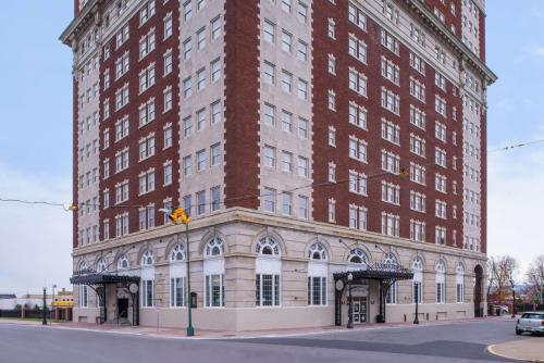 a large red brick building on a city street at DoubleTree by Hilton Utica in Utica