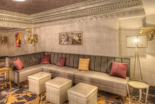 a living room with a couch and a table at DoubleTree by Hilton Utica in Utica