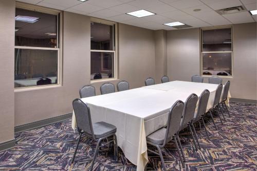 a conference room with a white table and chairs at DoubleTree by Hilton Utica in Utica