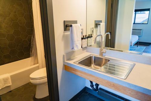 a bathroom with a sink and a toilet at Gravity Haus Winter Park in Winter Park
