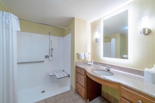 a bathroom with a sink and a shower and a mirror at Homewood Suites by Hilton Philadelphia-Valley Forge in Audubon