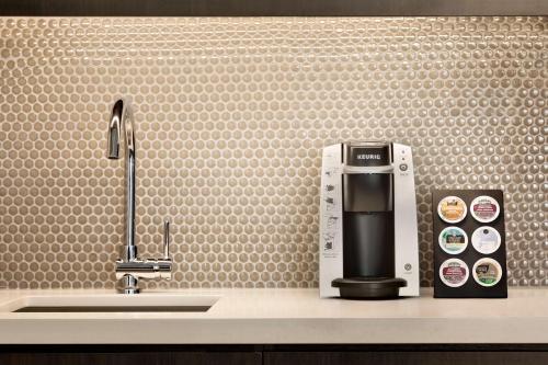 a coffee maker sitting on a counter next to a sink at Embassy Suites By Hilton Toronto Airport in Toronto