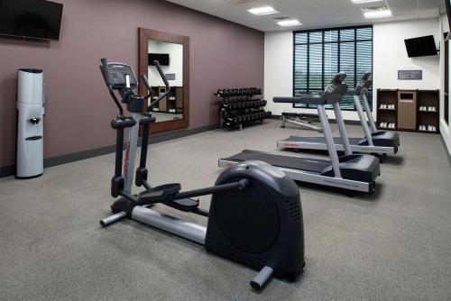 a gym with several tread machines in a room at Hilton Garden Inn Gallatin in Gallatin