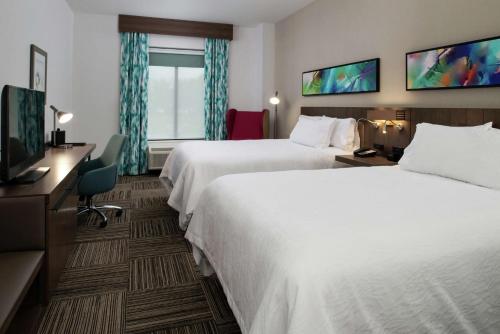 Habitación de hotel con 2 camas y TV en Hilton Garden Inn Gallatin en Gallatin