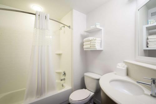 a white bathroom with a toilet and a sink at Hampton Inn Plymouth Meeting in Plymouth Meeting