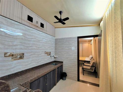 a bathroom with a sink and a ceiling fan at Shradha luxury room in Calangute