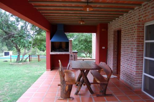 a wooden table and chairs sitting on a patio at Cabañas Mayma in Vaqueros