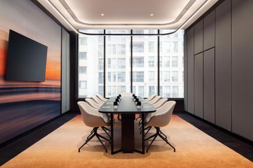a conference room with a table and white chairs at Canopy By Hilton Toronto Yorkville in Toronto