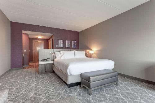 a bedroom with a large white bed and a chair at Hilton Garden Inn Toronto/Brampton West, Ontario, Canada in Brampton