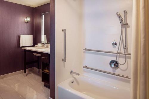 a bathroom with a bath tub and a sink at Homewood Suites by Hilton Needham Boston in Needham