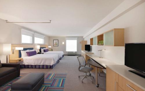 Home2 Suites by Hilton Austin North/Near the Domain, TX في أوستن: غرفة في الفندق مع سرير ومكتب
