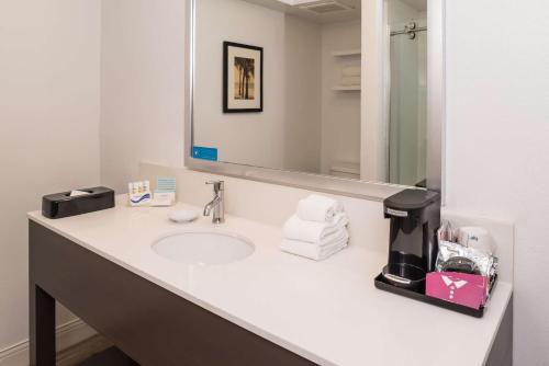 a bathroom with a sink and a mirror at Hampton Inn Channel Islands Harbor in Oxnard