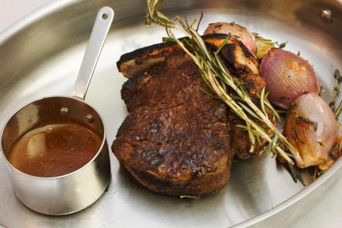 a plate of food with a piece of meat and sauce at Hilton Harrisburg near Hershey Park in Harrisburg
