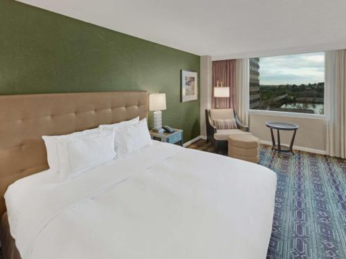 a hotel room with a large bed and a window at Hilton Harrisburg near Hershey Park in Harrisburg