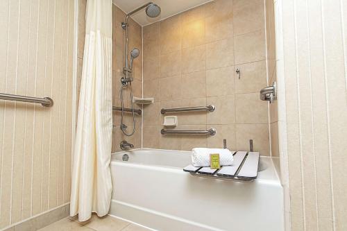 ein Badezimmer mit einer weißen Badewanne und einer Dusche in der Unterkunft DoubleTree by Hilton Lafayette in Lafayette