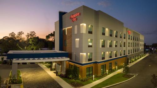 a hotel building with a sign on the side of it at Hampton Inn Pinellas Park St Petersburg, Fl in Pinellas Park