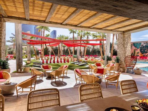 a patio at a resort with tables and chairs at Las Vegas Hilton At Resorts World in Las Vegas