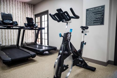 a gym with two exercise bikes and a treadmill at Estancia del Norte San Antonio, A Tapestry Hotel by Hilton in San Antonio