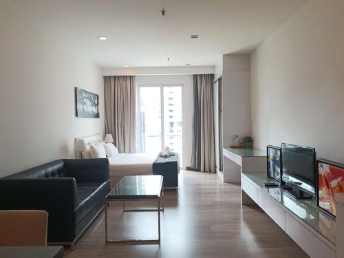a living room with a couch and a bed at RM219 Bukit Bintang Balcony Studio Infinty Pool in Kuala Lumpur