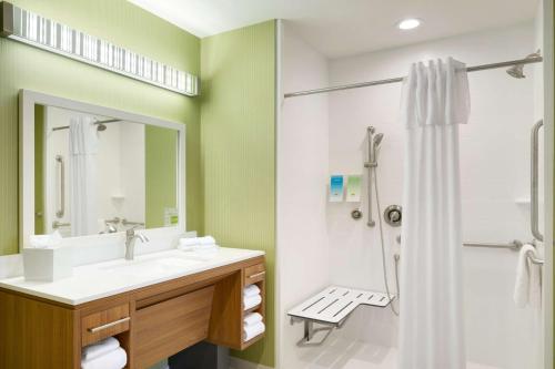 a bathroom with a sink and a shower at Home2 Suites by Hilton Charlotte Airport in Charlotte