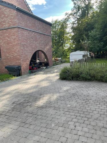 a brick building with a brick archway in front of it at Le Petit Parc in Wavre