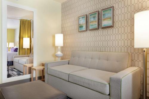 a living room with a couch and a bedroom at Home2 Suites by Hilton Salt Lake City-East in Salt Lake City