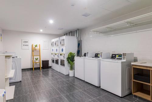 a room with a bunch of white appliances in it at Departamento de Estreno en Barranco in Lima