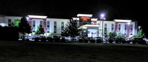 a parking lot in front of a hotel at night at Hampton Inn Bismarck in Bismarck