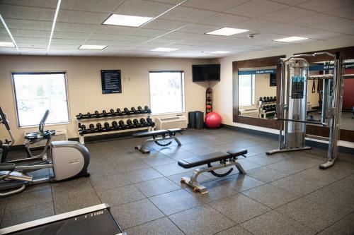 a gym with a lot of exercise equipment and a mirror at Hampton Inn Bismarck in Bismarck