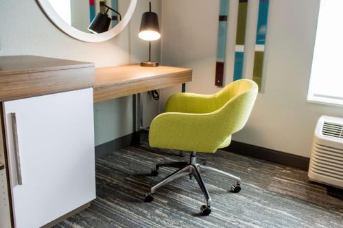 an office with a green chair in front of a desk at Hampton Inn Bismarck in Bismarck