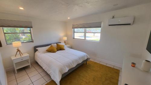 a bedroom with a bed and two windows at Modern Waterview House in Hudson