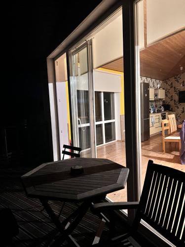 a table and chairs on a patio with a kitchen at Rannakivi Puhkemaja in Kärdla