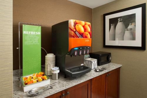 a kitchen counter with a coffee maker and a microwave at Hampton Inn Rochester Greece in Rochester