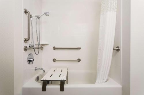 a bathroom with a bath tub with a bench in it at Hampton Inn by Hilton Kennewick at Southridge in Kennewick