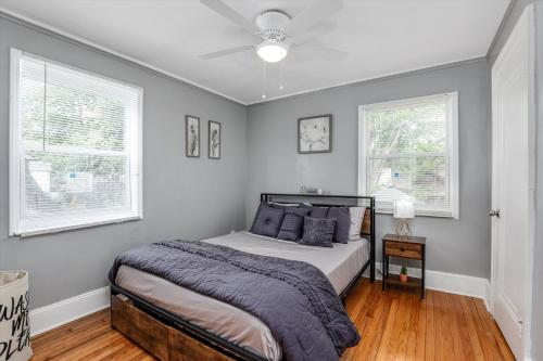 a bedroom with a bed and two windows at Modern & Cozy East Side Gem ~ Queen Beds ~ Parking in Detroit