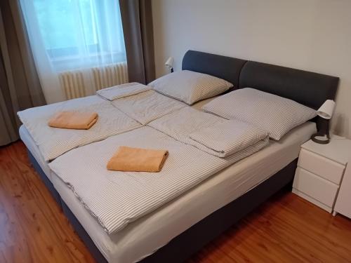 a bed with two towels on top of it at Apartmány Šrámek Stříbro in Stříbro