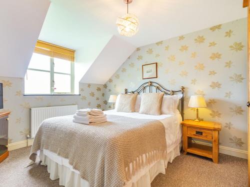 a bedroom with a large bed in a room at The Hayloft in Lostwithiel