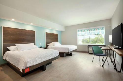 Säng eller sängar i ett rum på Tru By Hilton Lake Charles