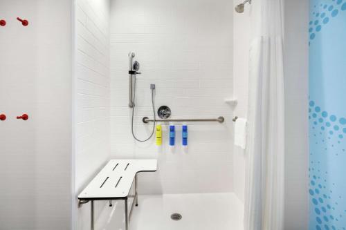 a white bathroom with a tub and a sink at Tru By Hilton Lake Charles in Lake Charles