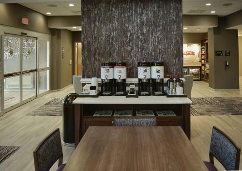 a restaurant with a counter with bottles of wine at Hampton Inn & Suites Philadelphia/Media in Media